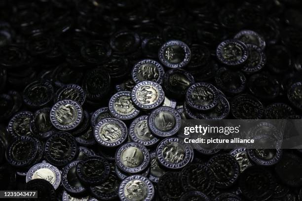 February 2021, Egypt, Cairo: Thousands of Egyptian 1-Pound coins are seen collected inside a sack at the production line of the Egyptian Public...