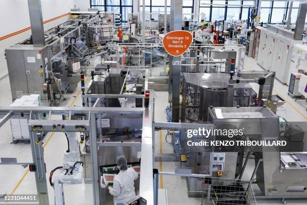 Employee is at work at the factory of British pharmaceutical company GlaxoSmithKline in Wavre on February 8, 2021 where the Covid-19 CureVac vaccine...