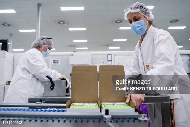 An employee is at work at the factory of British pharmaceutical company GlaxoSmithKline in Wavre on February 8, 2021 where the Covid-19 CureVac...