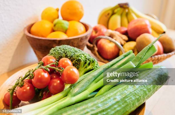 February 2021, Berlin: Different kinds of vegetables and fruits lie in baskets on a table in an apartment in Prenzlauer Berg. To stay healthy, a lot...