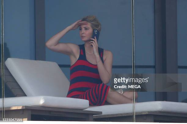 Ivanka Trump wears a red and black dress as she relaxes on her balcony on February 8, 2021 in Miami, Florida.