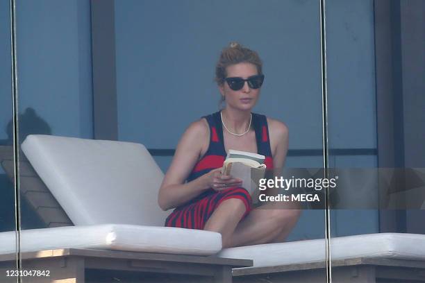 Ivanka Trump wears a red and black dress as she relaxes on her balcony on February 8, 2021 in Miami, Florida.