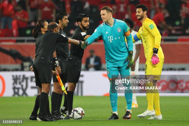 Ahly's goalkeeper Mohamed el-Shenawy and Bayern Munich's German goalkeeper Manuel Neuer greet the referees during the FIFA Club World Cup semi-final...