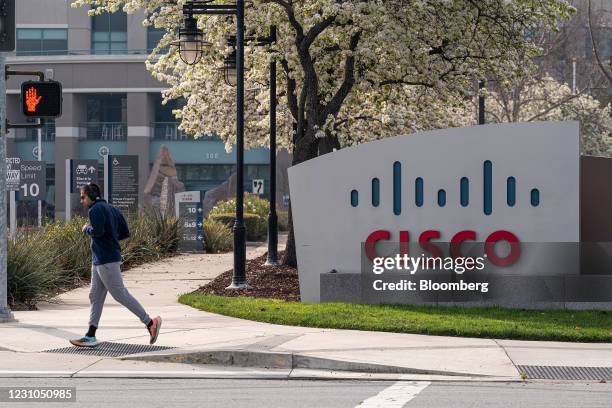 Runner jogs past Cisco Systems headquarters in San Jose, California, U.S., on Monday, Feb. 8, 2021. Cisco Systems Inc. Is scheduled to release...