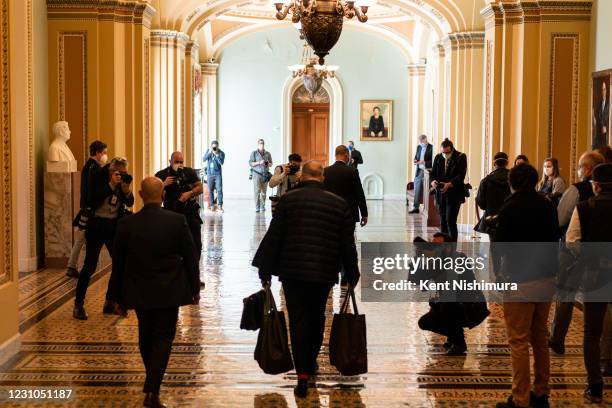 Senate Majority Leader Chuck Schumer arrives at the Senate side of the U.S. Capitol Building as a gaggle of press maneuvers around him on Monday,...