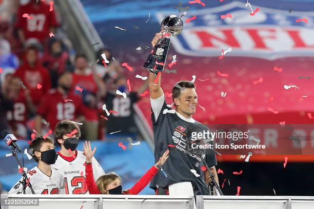 Super Bowl MVP Tom Brady of the Buccaneers holds the Lombardi Trophy as he is surrounded by his kids Benjamin Brady, John Edward Thomas Moynahan and...
