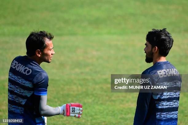 Bangladeshs Mominul Haque talks to his teammate Mushfiqur Rahim during a training session at the Sher-e-Bangla National Cricket Stadium in Dhaka in...