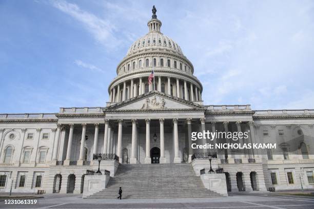 Member of the Capitol police walks past the US Capitol in Washington, DC, on February 9, 2021 before the start of former US president Donald Trump's...