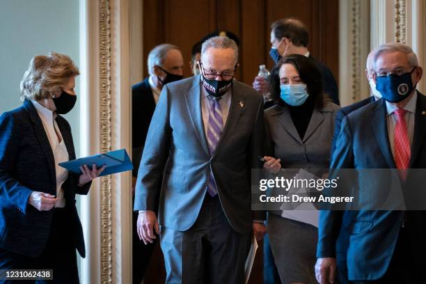 Sen. Debbie Stabenow , Senate Majority Leader Chuck Schumer , Sen. Maria Cantwell and Sen. Robert Menendez walk to a news conference on the first day...