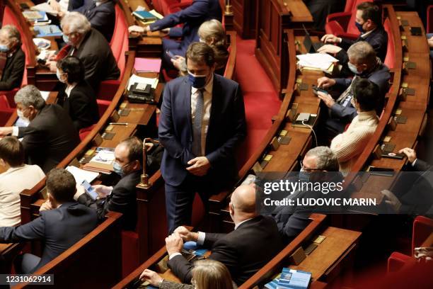 French centrist La Republique en Marche parliamentary group's president Christophe Castaner walks between seats during a session of questions to the...