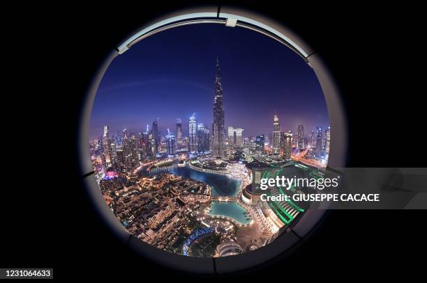 The skyline of Dubai and the high Burj Khalifa are pictured after sunset on February 9, 2021.