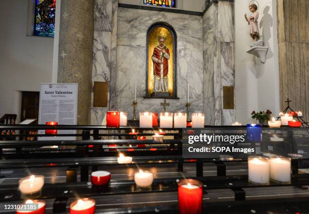 Candles in the chapel with the statue and relics of patron saint of love, St. Valentine, inside Whitefriar Church in Dublin. On St. Valentine's Day,...