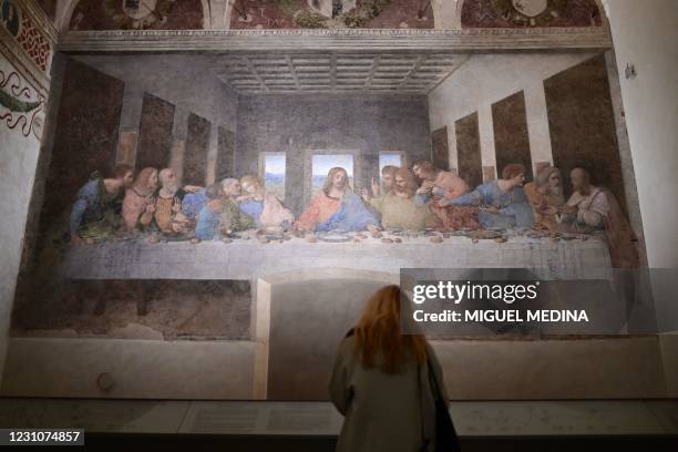 Visitor watches "The Last Supper" , Italian artist Leonardo da Vinci's late 15th-century mural painting housed by the refectory of the Convent of...