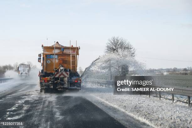 Truck spreads salt on a snowy road that lead to Le Mont-Saint-Michel, Normandy, northwestern France, on February 10 following over night snow.