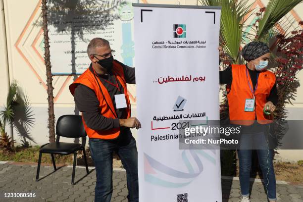 Palestinian members of Central Elections Commission open the first Voter Information and Registration Centre in Gaza City on February 10, 2021. -...