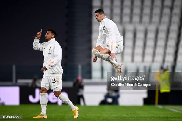 Cristiano Ronaldo of Juventus FC jumps while Danilo Luiz da Silva of Juventus FC gestures after entering the pitch during the Coppa Italia football...