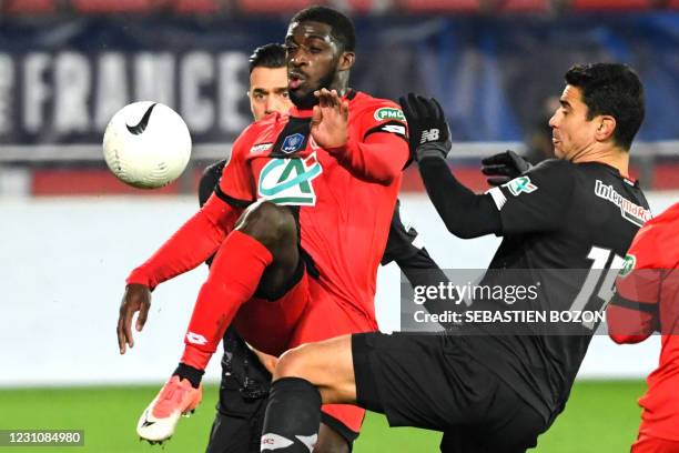 Dijon's French forward Aboubakar Kamara fights for the ball with Lille's French midfielder Benjamin Andre during the French Cup round-of-64 football...