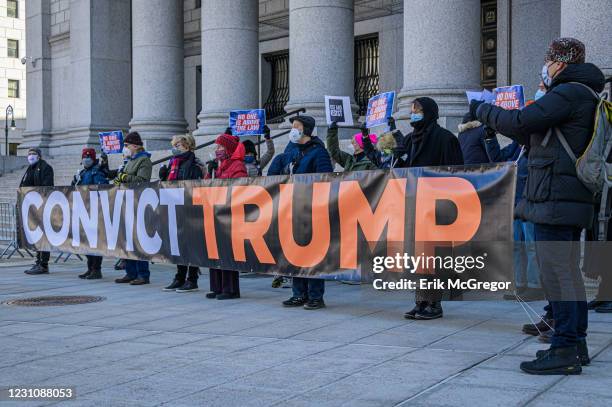 Participants holding a banner reading: "CONVICT TRUMP" at the protest. On the beginning day of Trump's impeachment trial, members of the NYC activist...