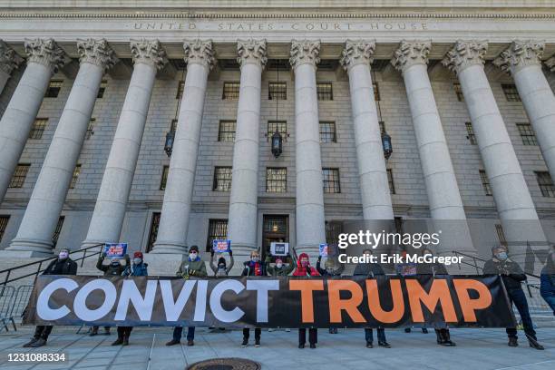 Participants holding a banner reading: "CONVICT TRUMP" at the protest. On the beginning day of Trump's impeachment trial, members of the NYC activist...