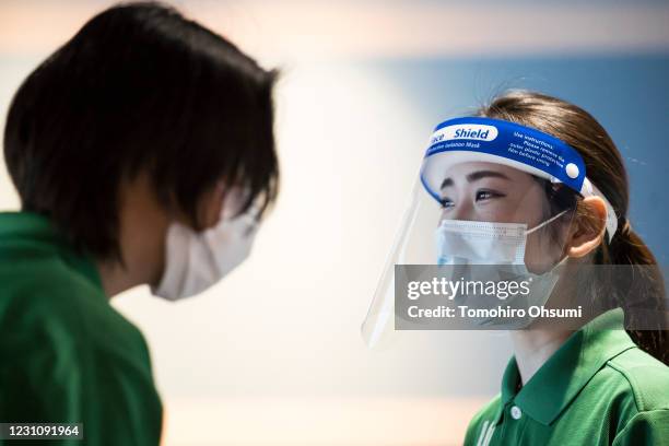 An employee wearing a face shield takes part in a training session for employees held ahead of the reopening of the Hakkeijima Sea Paradise theme...