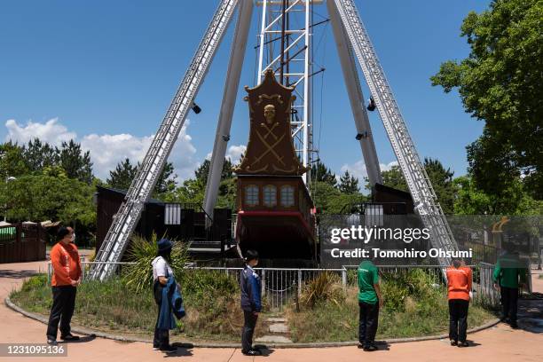 Employees playing the role of customers wait in line keeping social distancing during a training session for employees held ahead of the reopening of...