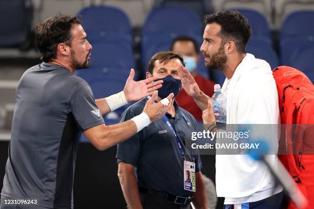 Italian player Salvatore Caruso and Fabio Fognini argue after their men's singles match on day four of the Australian Open tennis tournament in...