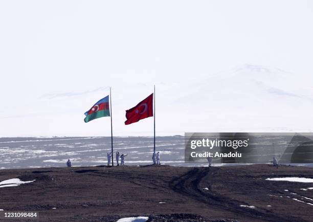 Soldiers stand under national flags of Azerbaijan and Turkey during the "Winter-2021 Military Drill" organized by the Turkish Armed Forces in...