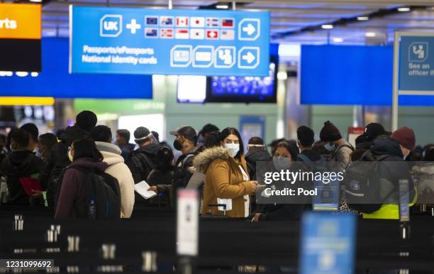 People queue at UK border control at Terminal 2 at Heathrow Airport on February 11, 2021 in London, England.