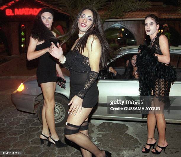 Lebanese men dressed as women pose outside El-Matador night club in the port city of Jounieh, north of Beirut, late 03 December 1999 to celebrate the...