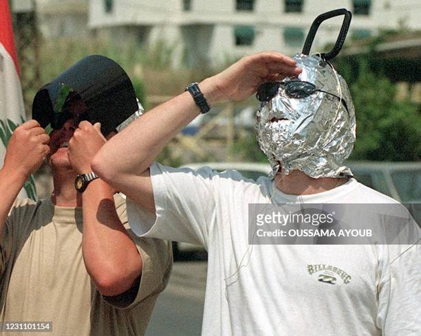Eclipse watchers in Beirut find novel means of protecting ther eyesight while viewing the last total solar eclipse of the century 11 August 1999....