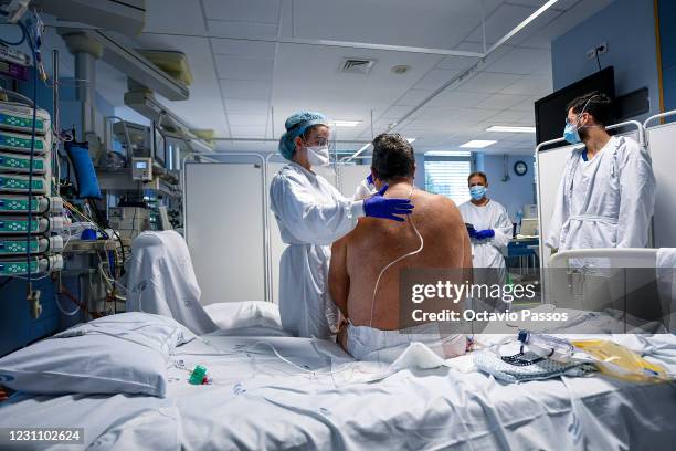 Healthcare workers work with a patient in the Covid-19 intensive care unit at Hospital Universitario de São João, on February 11, 2021 in Porto,...