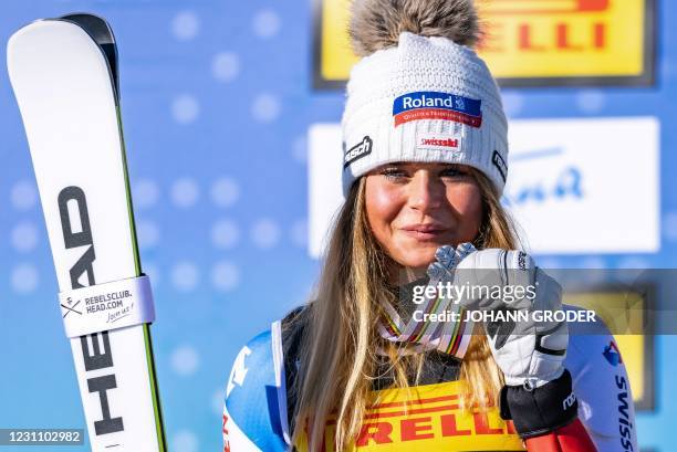 Silver medallist Switzerland's Corinne Suter poses on the podium after the Women's Super G event on February 11, 2021 during the FIS Alpine World Ski...