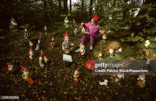 Lady dressed as a gnome repainting her collection of gnomes at the Gnome Reserve at West Putford, North Devon, England, circa May 1985. This image is...