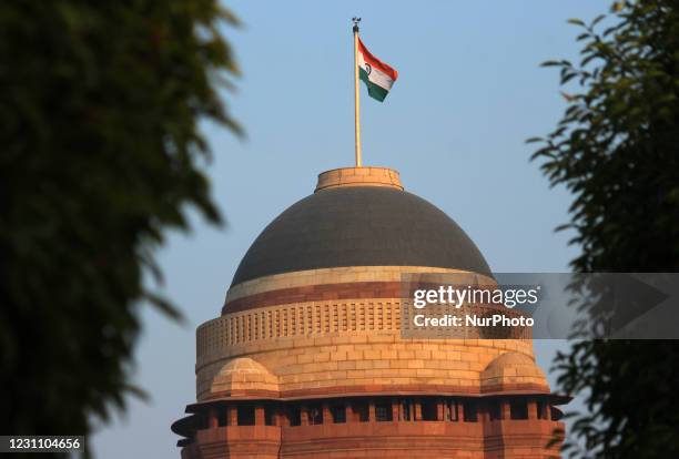 Indian national flag flutters over the dome of the Rashtrapati Bhavan as seen from Mughal Gardens, in New Delhi, India on February 11, 2021. The...