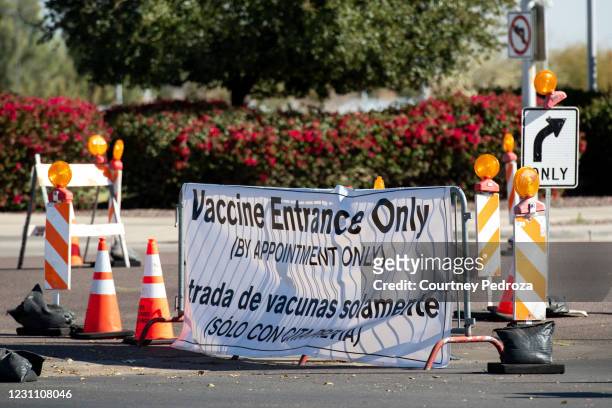 Sign directs people to receive the COVID-19 vaccination at State Farm Stadium on February 11, 2021 in Glendale, Arizona. Maricopa County is in phase...