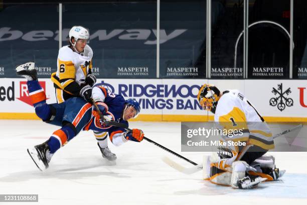 Casey Cizikas of the New York Islanders scores a goal past Casey DeSmith of the Pittsburgh Penguins as John Marino defends during the first period at...