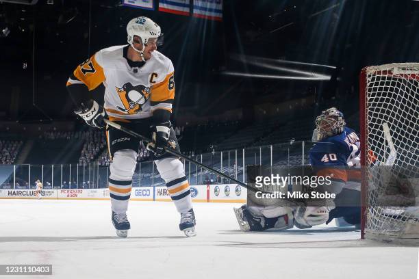 Sidney Crosby of the Pittsburgh Penguins scores a goal during the shootout past Semyon Varlamov of the New York Islanders at Nassau Coliseum on...