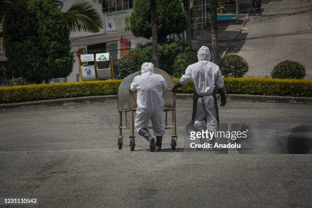 Cemetery workers exhume the body of a person buried four years ago at the Nuestra Senora de Belen cemetery, in Fusagasuga, Colombia, February 11,...