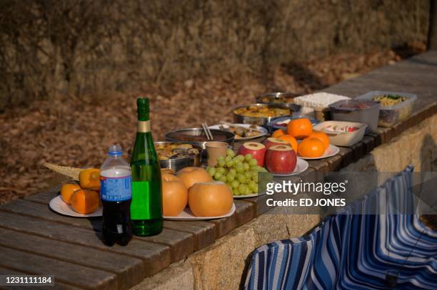 Food offering is displayed as a family prepare to perform a lunar new year ceremony to make an offering to their relatives in North Korea, at the...