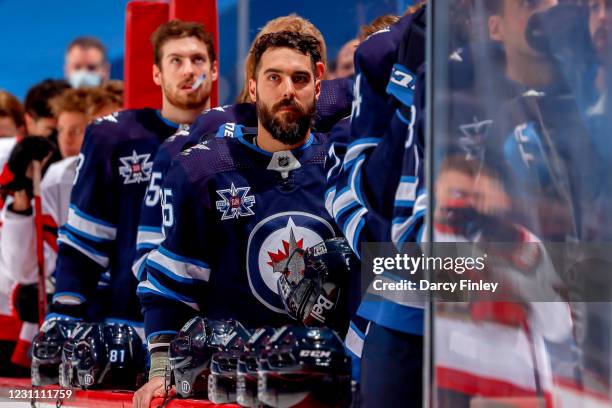 Mathieu Perreault of the Winnipeg Jets looks on from the bench prior to puck drop against the Ottawa Senators at the Bell MTS Place on February 11,...