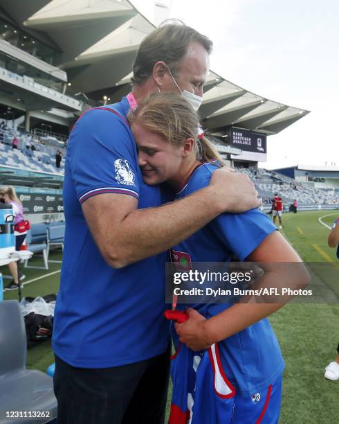 Isabella Grant of the Bulldogs is embraced by her father Chris Grant after receiving her jumper before the 2021 AFLW Round 03 match between the...