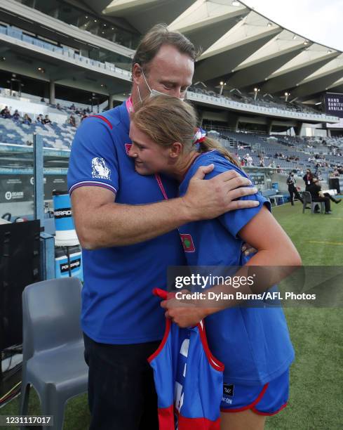 Isabella Grant of the Bulldogs is embraced by her father Chris Grant after receiving her jumper before the 2021 AFLW Round 03 match between the...