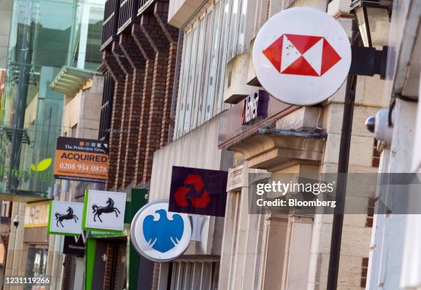 Signs outside branches of a Lloyds Banking Group Plc bank, a Barclays Bank Plc bank, a NatWest Group Plc bank, and a HSBC Holdings Plc bank in...