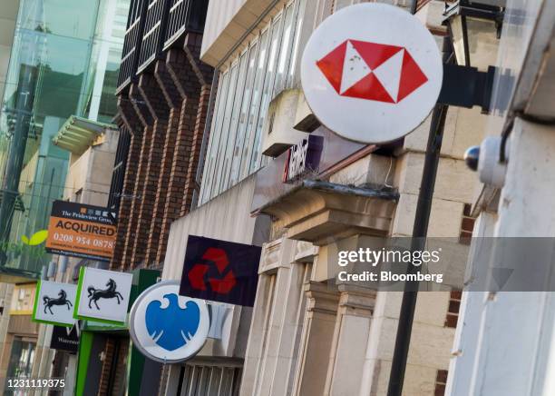 Signs outside branches of a Lloyds Banking Group Plc bank, a Barclays Bank Plc bank, a NatWest Group Plc bank and a HSBC Holdings Plc bank in...