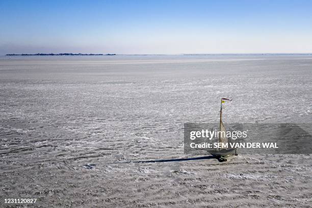 Aerial view shows Ice Yachting, a recreational boat supported by metal runners, steered with a rear blade and sails to carry it over the ice on Lake...