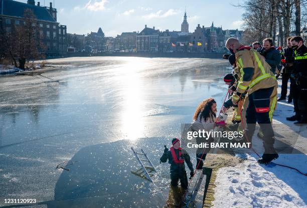 Emergency services help ice skaters off the Hofvijver pond as numerous skaters ran into problems when the ice began to melt, in The Hague on February...