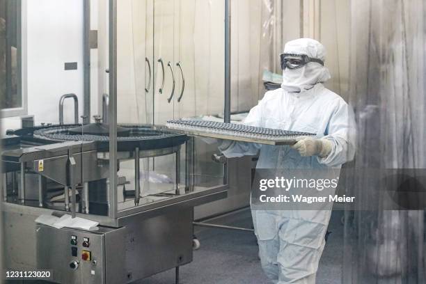 Laboratory technician prepares vials of the first experimental batch of the AstraZeneca/Oxford vaccines against Covid-19 at the Institute of...