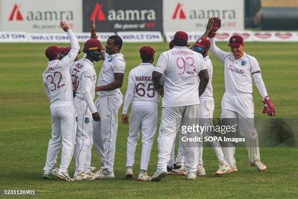 West Indies cricketers celebrate after the dismissal of Bangladesh's player during the second day of the second Test cricket match between West...
