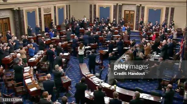 In this screenshot taken from a congress.gov webcast, members of Congress stand to applaud Capitol Police officer Eugene Goodman on the fourth day of...