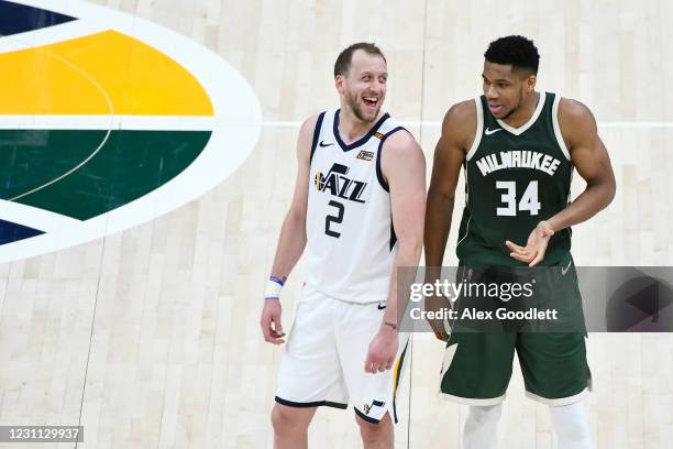 Joe Ingles of the Utah Jazz jokes with Giannis Antetokounmpo of the Milwaukee Bucks during a game at Vivint Smart Home Arena on February 12, 2021 in...